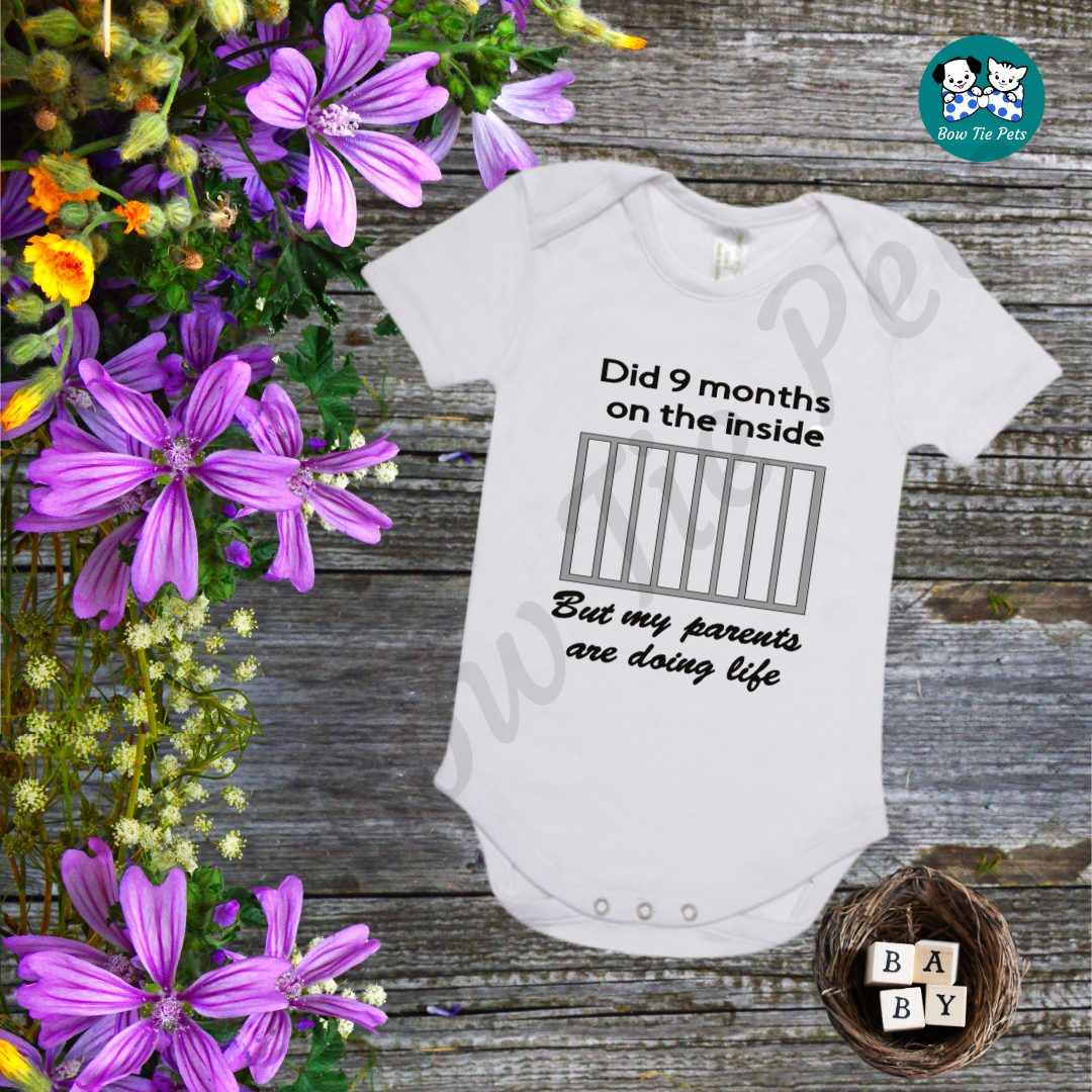 "Did 9 Months on the inside, but my parents are doing life" Baby Romper available in sizes 0000, 000, 00, 0. White romper with black writing and silver gaol bars. 