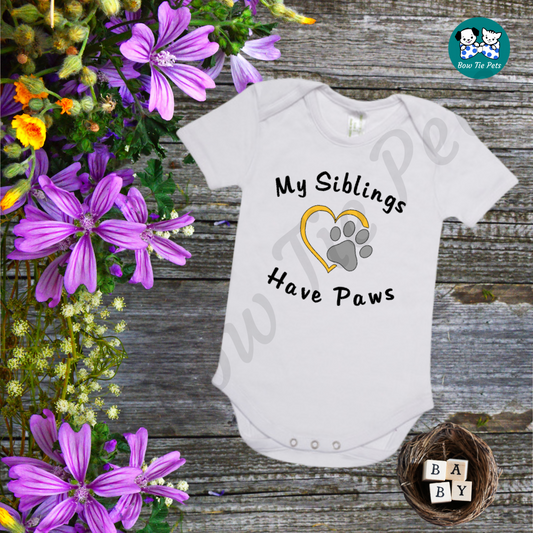 "My Siblings Have Paws" White romper, black writing with a gold heart and silver paw print